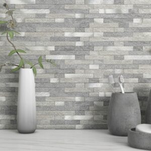 Stylish gray stone wall with decorative vases and a branch
